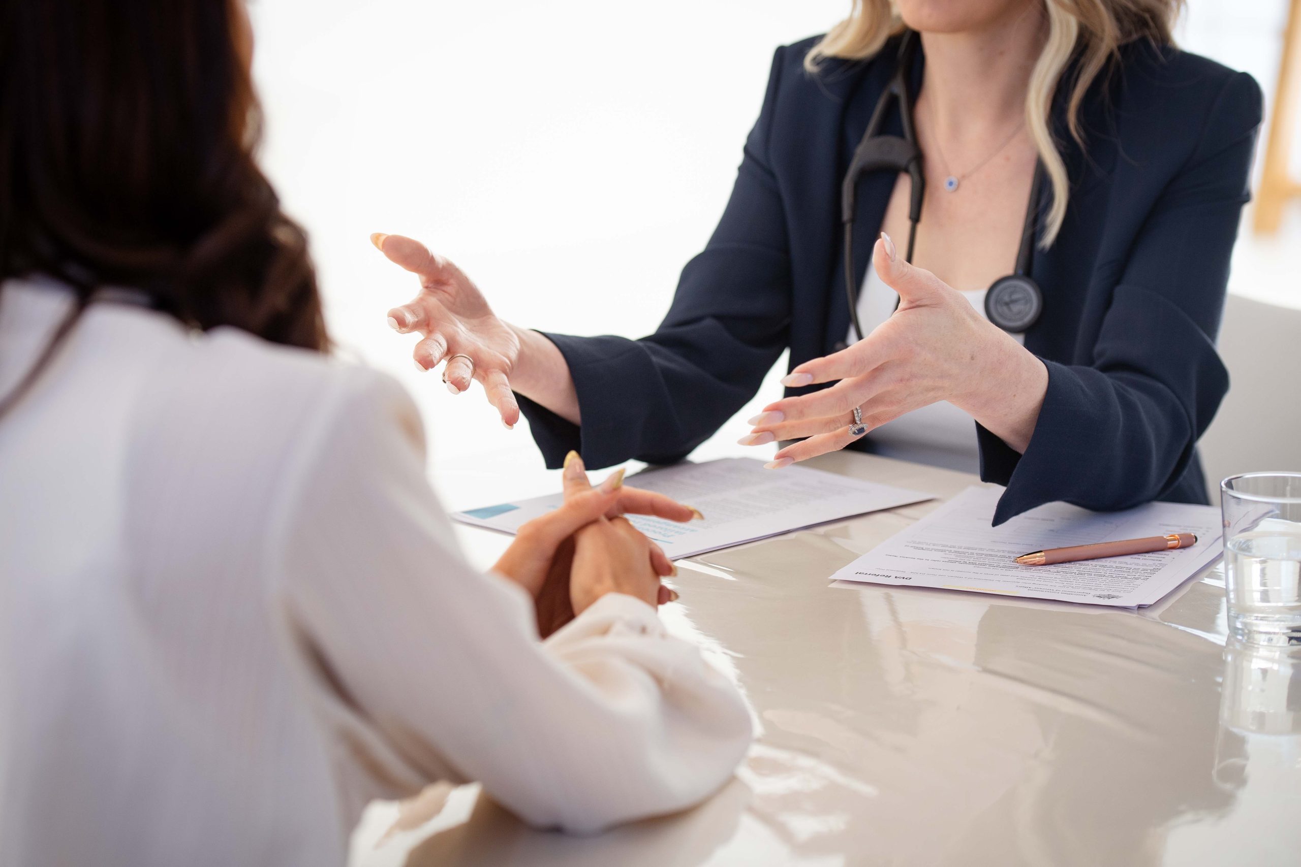 hands talking to a client at the table